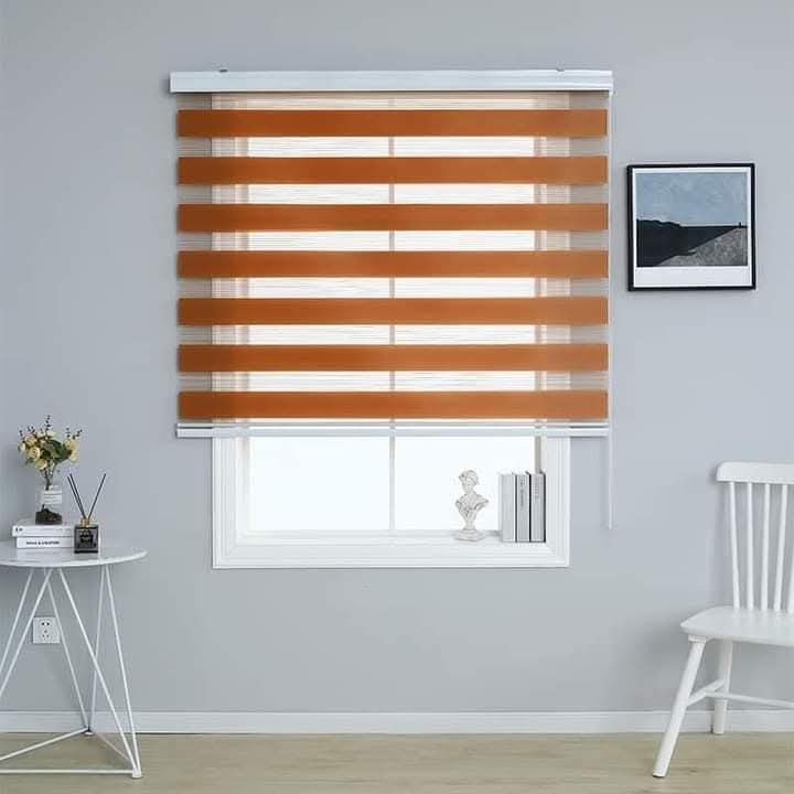 Orange zebra blind over a small window